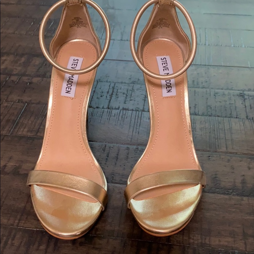 Gold open toe high heels.